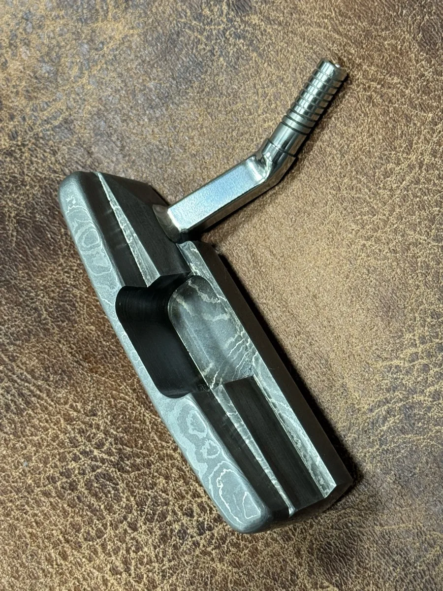Wild hair and a block of Damascus. Not really shaped to resemble anything, but she'll probably go on a "Thin My Bumpers" — photo 1 of 5