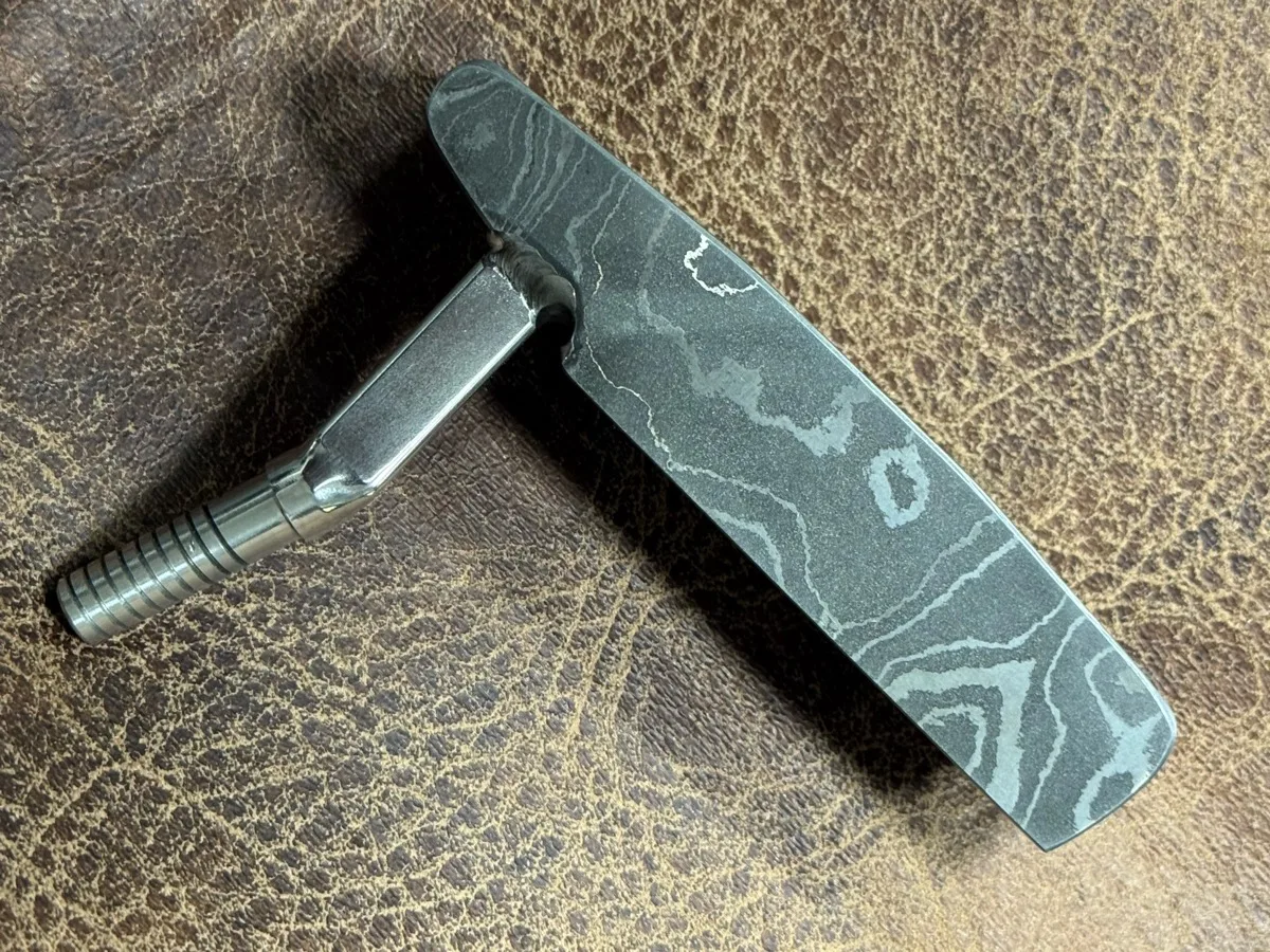 Wild hair and a block of Damascus. Not really shaped to resemble anything, but she'll probably go on a "Thin My Bumpers" — photo 2 of 5